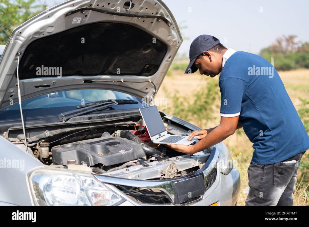 professional-mechanic-using-laptop-for-checking-car-by-lifting-car-hood-on-highway-road-concept-of-technology-mobile-repair-service-and-support-2HX6TMT